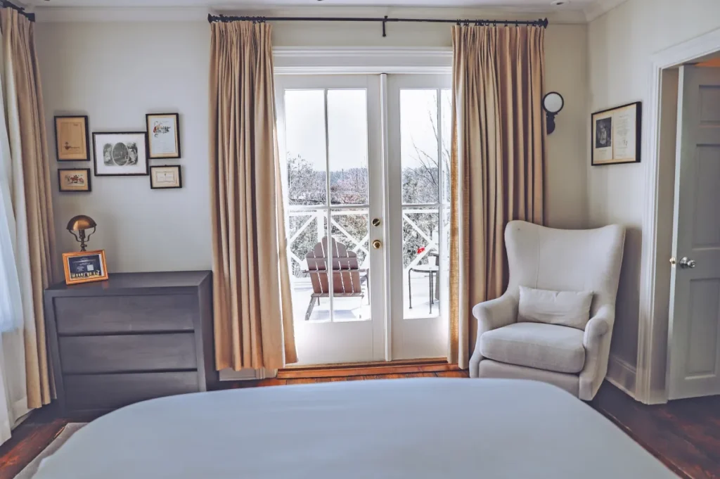 a bedroom with a white bed and a white chair