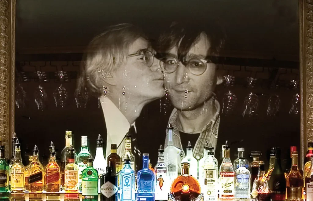 a man and a woman kissing in front of bottles of liquor
